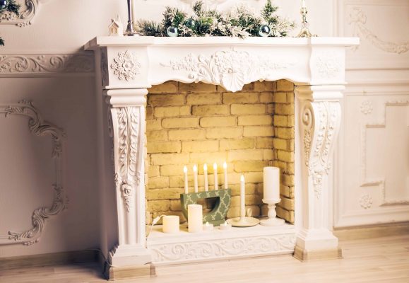 Beige Classic Fireplace Mantel with Candles and Christmas decor in Home