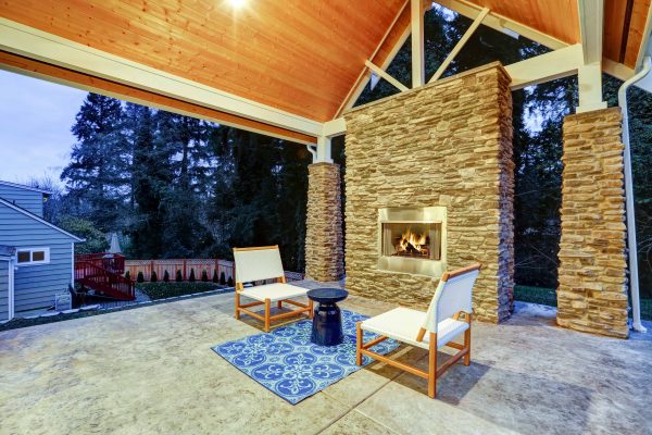 Chic covered back patio with built in gas fireplace