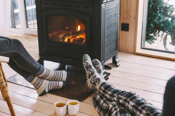 Wood stove in brick fireplace people drinking tea